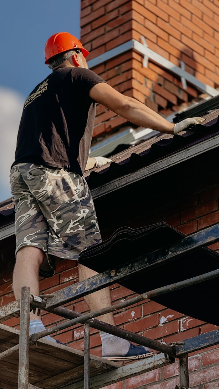 Mastering the First Impression: Your intriguing post title goes here A construction worker wearing a hard hat works on a residential roof repair.